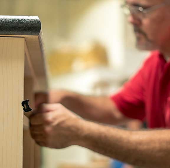 Man measuring a piece of furniture